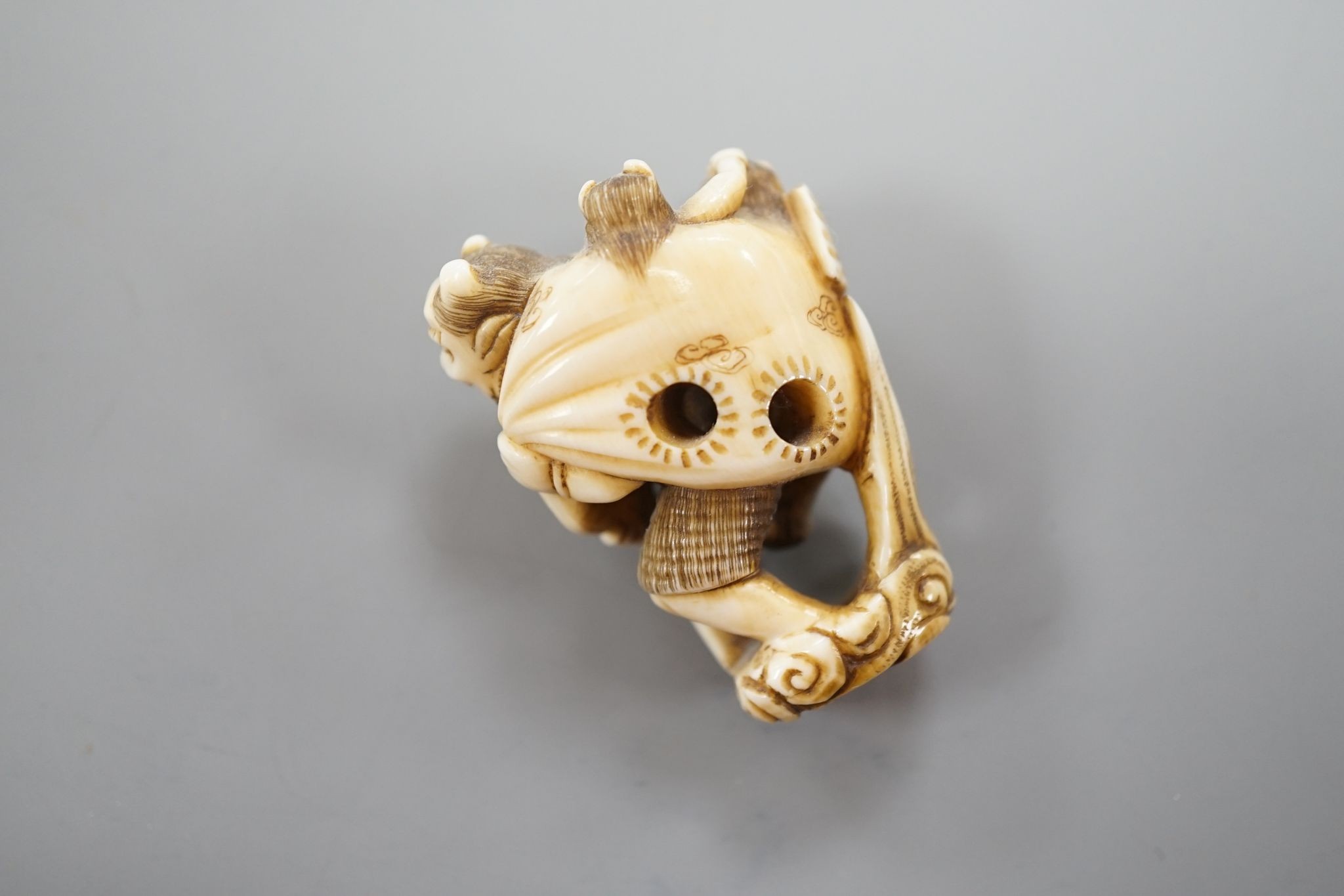 A Japanese ivory netsuke of oni, Meiji period, 4 cms high.